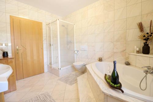 a bathroom with a tub and a toilet and a sink at Naturtalente Berghaus - Apartment 4 in Innerschwand am Mondsee