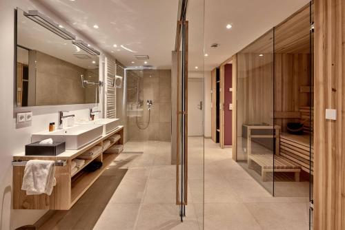 a bathroom with a sink and a shower at Staufen Chalets am Kalvarienberg in Oberstaufen