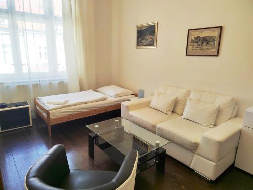 a living room with a couch and a table at Tower Apartments in Prague