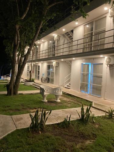 a large building with a bench in front of it at Hotel Casa Del Angel in Chetumal