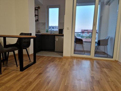 a kitchen and dining room with a table and chairs at Luxury Apartment IVA III in Skopje