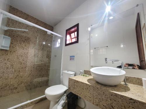 a bathroom with a sink and a toilet at Pousada Cielo Blu in Búzios
