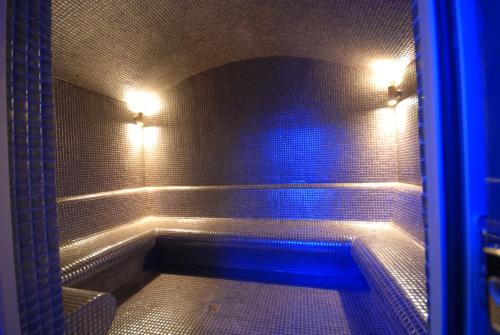 a bathroom with a tub with blue lights at Suhan Cappadocia Hotel & Spa in Avanos