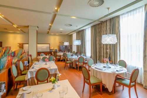 ein Restaurant mit Tischen und Stühlen und einem großen Fenster in der Unterkunft Ponferrada Plaza in Ponferrada