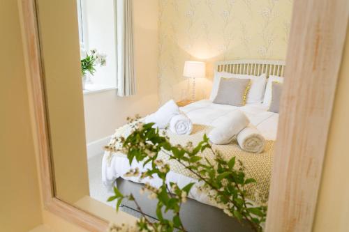 a bedroom with a bed with a mirror at Cae Mab Dafydd in Llanfairfechan