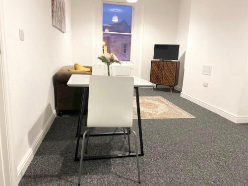 a room with a white table and a couch at Home in Bridgwater