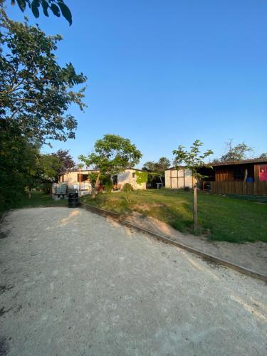 a gravel road in front of a house at La cabane familiale in Champdieu