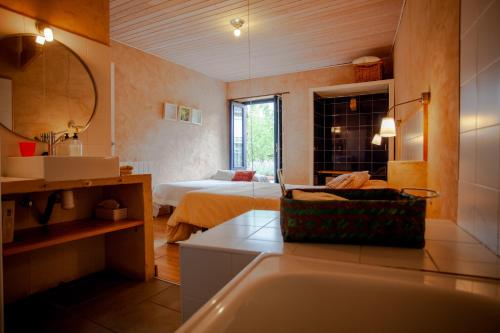 a bathroom with a sink and a bed in a room at CASA COLOMBA in Santa Colomba de Somoza