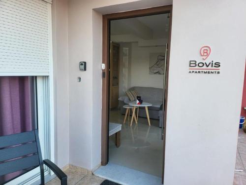 a door leading into a room with a living room at Bovis Apartments #1 in Markopoulo