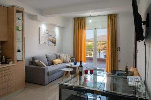 a living room with a couch and a table at Bovis Apartments #1 in Markopoulo