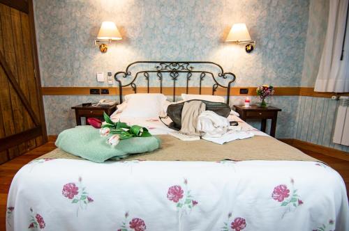 a bedroom with a bed with two pillows on it at TERRA de Lestrove - Quality Rooms in Padrón