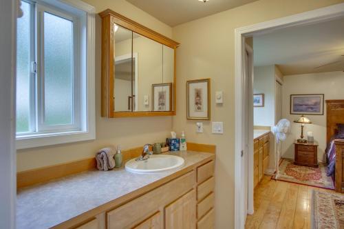 een badkamer met een wastafel en een spiegel bij Owls Nest - Cozy Cabin with Hot Tub and Fireplace! in Gold Bar