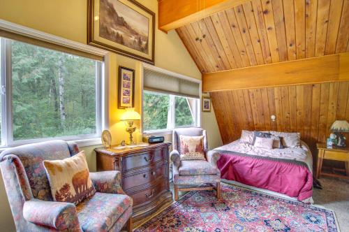 a bedroom with a bed and a chair and a window at Swim, Hike and Fish Owls Nest Gold Bar Cabin in Gold Bar