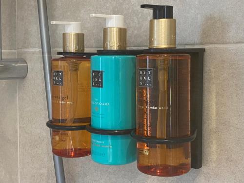 a group of four different colored liquids on a shelf at La Reserva de Los Campos in Cadavedo