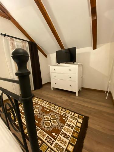 a living room with a tv and a dresser at Casa Moldovan ( Coltisorul meu de rai) in Ocna Şugatag