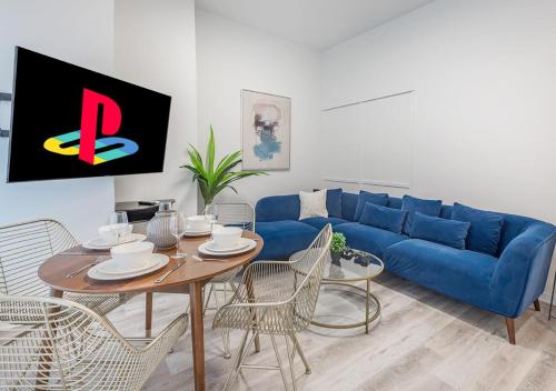 a living room with a blue couch and a table at Luxurious 3BD Apt in heart of downtown 5 min walk to Bell Center in Montréal
