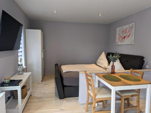 a small living room with a table and a couch at Ferienunterkünfte Zwischen Meer & See in Bansin