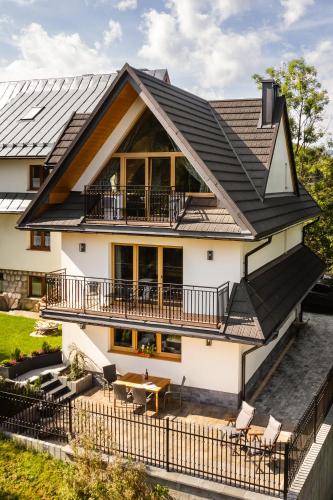 an image of a house with a metal roof at Apartamenty Blisko TATR Zakopane in Zakopane