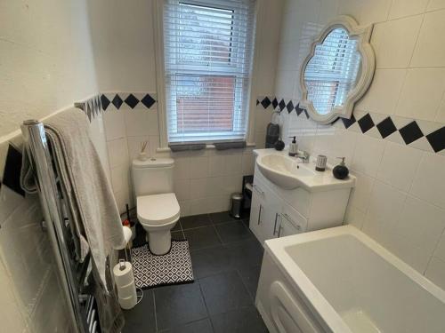 a bathroom with a toilet and a sink at 3 bed flat+parking- by beaches in Parkstone