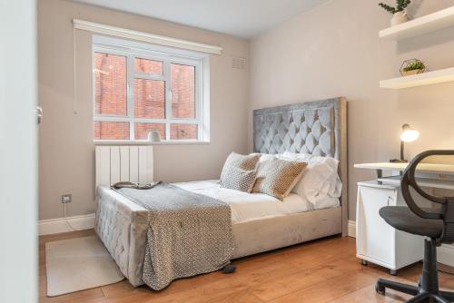 a bedroom with a bed and a window at Central Whitechapel - Steps from Station & Sights! in London