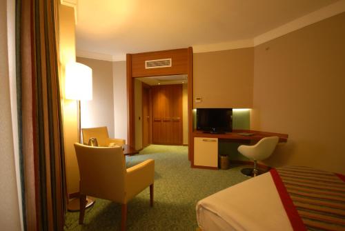 a hotel room with a bed and a desk at Suhan Cappadocia Hotel & Spa in Avanos