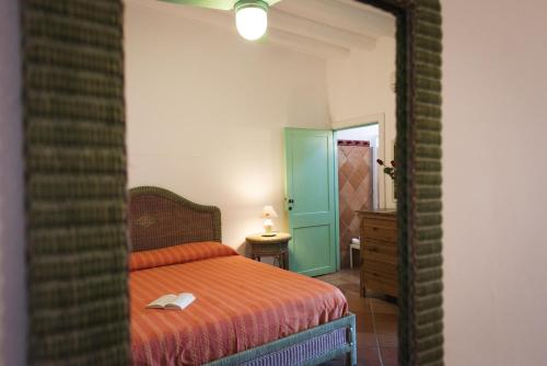 a bedroom with a bed and a hallway with a mirror at Villa Mareblu Luxury Holiday Apartment direttamente sul mare in Stromboli