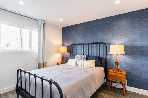 a bedroom with a large bed with a blue accent wall at Casa Nova - Central San Diego FREE parking in San Diego