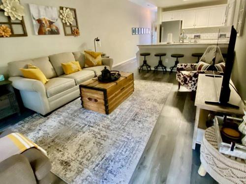 a living room with a couch and a coffee table at Cozy Corner - Family Beach Vacation Condo in Wilmington