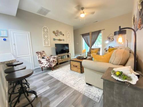 a living room with a couch and a tv at Cozy Corner - Family Beach Vacation Condo in Wilmington