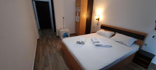 a bedroom with a bed with two towels on it at Hotel Blue Sky Resort in Eforie Nord