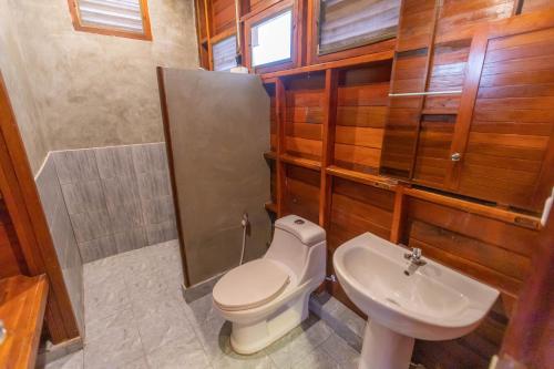 a bathroom with a toilet and a sink at เดอะวอเตอร์ปาร์ครีสอร์ท- The Water Park Resort in Ban Laem Mong Khoi