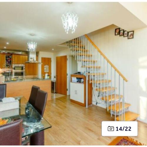 a living room with a staircase in a house at Penthouse Experience in South Norwood