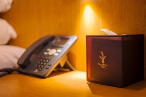a telephone and a box sitting on a table at Sago Palm Hotel in Ocho Rios