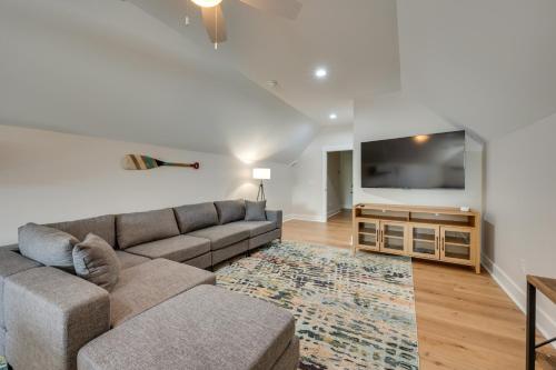 a living room with a couch and a flat screen tv at Spacious Lake Sinclair Vacation Rental with Dock! in Resseaus Crossroads