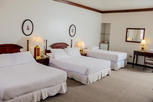 Rúm í herbergi á Nobile Suites Excelsior Asuncion