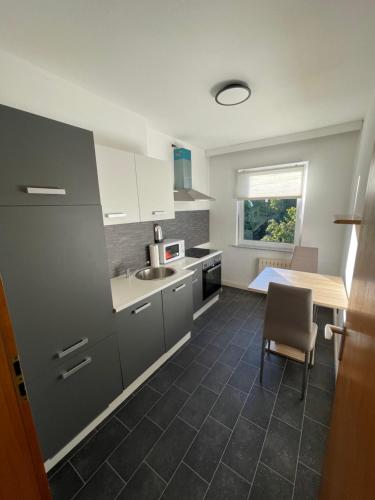 a kitchen with a table and a sink and a counter at City Apartment Lux Bremen in Bremen