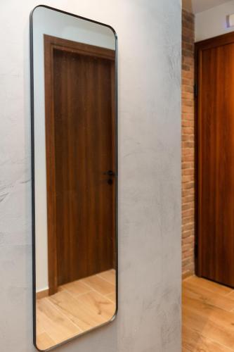 a mirror hanging on a wall with a door at Valaoritou 3 Luxury Rooms in Thessaloniki