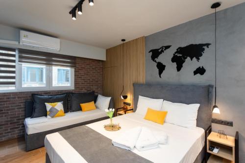 a bedroom with two beds and a map of the world on the wall at Valaoritou 3 Luxury Rooms in Thessaloniki