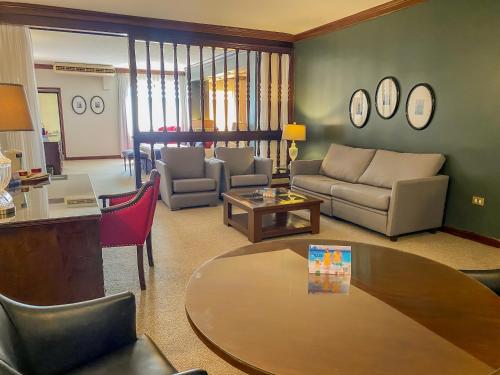 a living room with a couch and a table at Nobile Suites Excelsior Asuncion in Asuncion