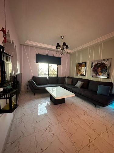 a living room with a couch and a coffee table at Abu alzoz home سكن مشترك in Amman