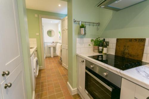 a kitchen with a sink and a stove top oven at Hyfrydle in Beaumaris
