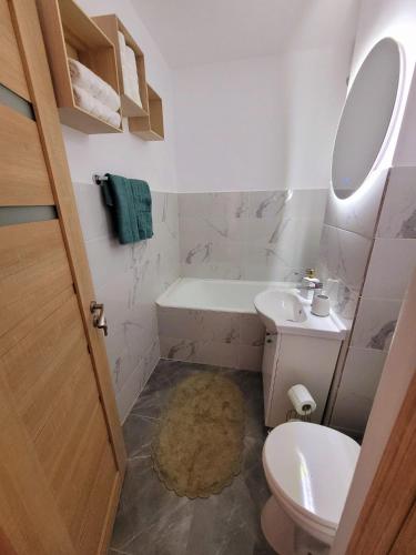 a bathroom with a toilet and a sink at Christal Apartment in Bacău