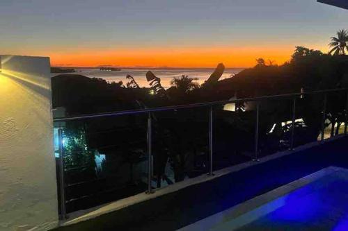 a view of the ocean from a balcony at sunset at Sunset Villa Bora Bora in Bora Bora