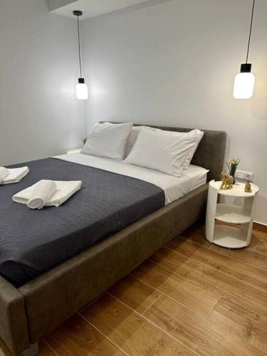 a large bed in a bedroom with two towels on it at Moschato Stylish Home 1 VIPGreece in Piraeus