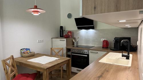 a kitchen with a wooden table and a counter top at Zum Radwerk TOP 11 in Vordernberg