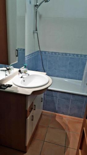 a bathroom with a sink and a shower and a tub at HOME4U - Fantastic 2 bedroom apartment, with pool in Cabanas de Tavira