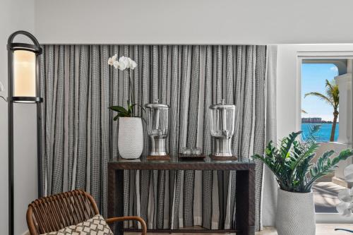 a living room with a table with vases on it at Las Casitas Village at El Conquistador in Fajardo