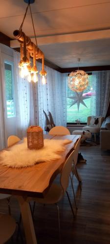 comedor con mesa y lámpara de araña en Magic lapland villa, en Rovaniemi