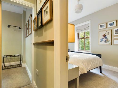 a bedroom with a bed and a window at Stoneswood Cottage & Garden, Delph, Saddleworth in Delph