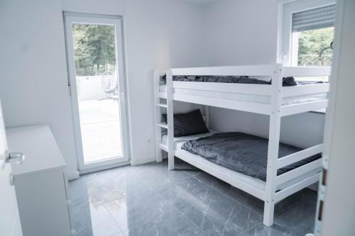 a room with two bunk beds and a window at Villa J&J in Sesvete